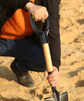 Spade Handle Replacement For Snow Shovels With 32mm Inner Diameter Plastic D Grip Style being used in sandy soil