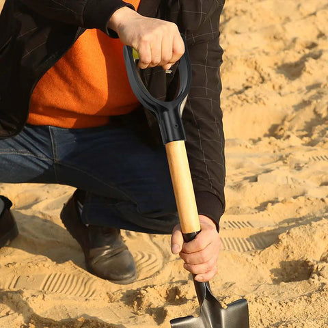 Spade Handle Replacement For Snow Shovels With 32mm Inner Diameter Plastic D Grip Style being used in sandy soil