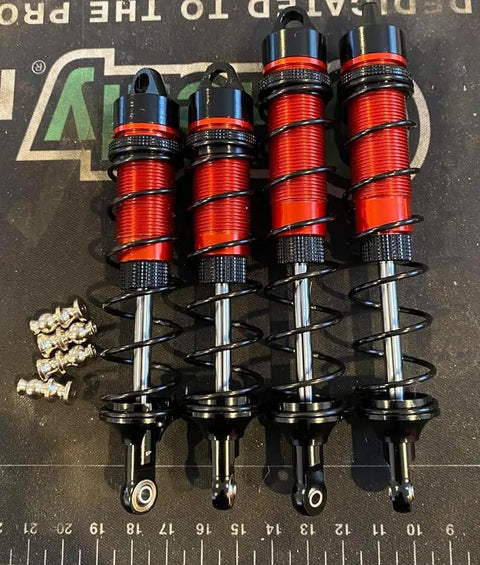 Beefy Front And Rear Adjustable RC Car Shocks Set For 1/8 Scale Fits Arrma Typhoon 6S Redcat FS ZD Racing Buggy Truggy Replacement Parts Aluminum Dampers Easy Install Durable Performance shown in red and black aluminum on a mat.