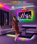 Woman dancing in room with Dreamcolor RGBIC LED Strip Lights 33ft For Bedroom With App Control Music Sync Remote And USB Smart Light Strips, colorful effects.
