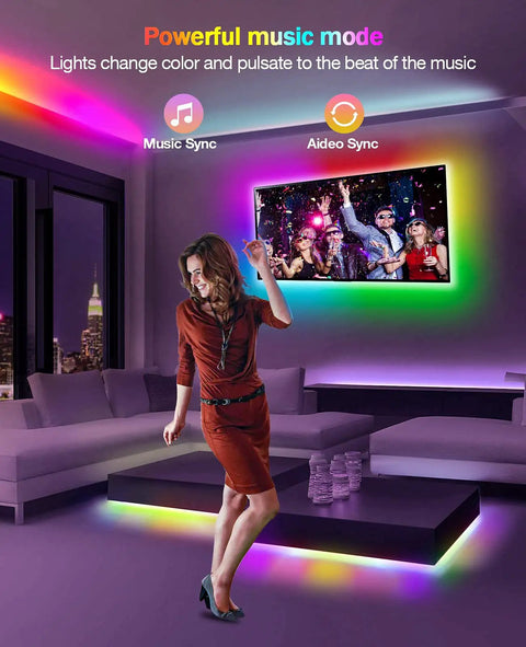 Woman dancing in room with Dreamcolor RGBIC LED Strip Lights 33ft For Bedroom With App Control Music Sync Remote And USB Smart Light Strips, colorful effects.