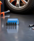 Easy Impact Socket Bolt Extractor Kit For Stripped Nuts And Screws With Steel And Plastic Build Precision Gear 17 19 21 22 24mm Sizes Perfect Garage Fix And Auto Repair Tool To Break Loose Frozen Fasteners Quick And Dirty. Blue case with 17-24mm sockets beside a car wheel