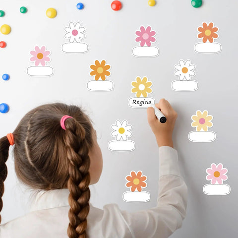 Child using Retro Groovy Floral Name Tag Stickers with Daisy Flower Nameplates on whiteboard for classroom decor