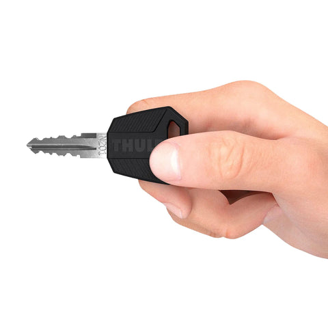 Hand holding Comfort Key from One Key Lock System Four Pack For Thule Gear Silver And Black Replace All Locks Quickly With The Same Key