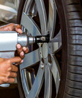 Heavy Duty Pro Grade Impact Socket Set One Half Inch Drive Deep Chromium Molybdenum 6 Point Axle Nut Sockets in use on car wheel