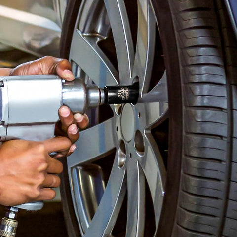 Heavy Duty Pro Grade Impact Socket Set One Half Inch Drive Deep Chromium Molybdenum 6 Point Axle Nut Sockets in use on car wheel