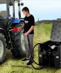 Person using Portable Diesel Tank Built Tough, 58 Gallon Capacity With 12V Electric Transfer Pump next to tractor