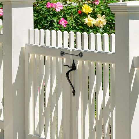 Stainless Steel Gate Hook and Eye Latch for Cabinet Door Window Shed Barn attached to a white picket fence gate.