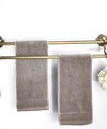 Antique Brass Adjustable Double Towel Bar Wall Mount Rack For Bathroom, holding two towels and accessories, vintage style.