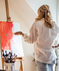 Woman using a Professional Heavy Duty Rubber Ink Roller For Printmaking And Canvas Painting on an easel.