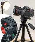 Camera on tripod with close-up inset of tripod adjustment with red handle, studio lighting in background.