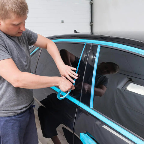 Man applying Vinyl Pinstripe Masking Tapes Six Pack High Temp Low Tack Automotive Painter Tape on car window trim