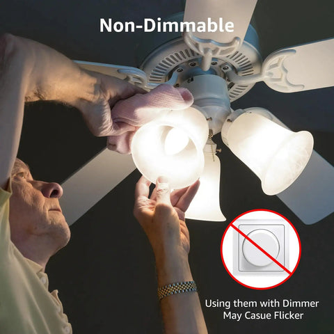 Person installing bright 5.5W LED B11 candelabra bulbs 5000K daylight white not dimmable 40W equivalent in ceiling fan