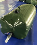 Foldable Water Storage Bladder With Faucet 110L Portable Camp Ready Collapsible Water Tank on blue surface
