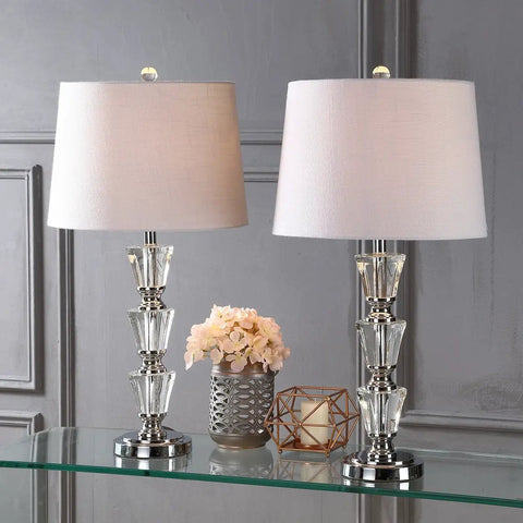 27 Inch Clear Crystal Table Lamp Set Of 2 With Glam Traditional Chrome Accents, White Linen Shade, placed on a glass table