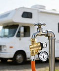 TONDA RV water pressure regulator with brass body, gauge, and orange hose on an RV water line.