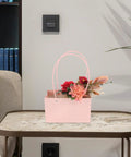 Pink Flower Bouquet Bags With Handle 10 Pack Pro Grade Kraft Paper Floral Packaging Bags on a table with flowers