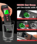 Digital pH Meter With Color LCD Backlit Display And UL Certified Accuracy in a glass, showing green bulb feature.