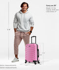 Man standing next to pink carry-on luggage showing size