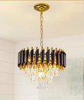Gold and black modern chandelier with teardrop crystals in dining room