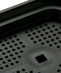 Close-up of anti vibration pad with textured surface for washing machines and dryers, heavy duty floor protection and shock absorbing guards.