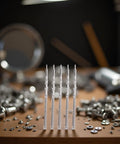 Five Piece Silver Movement Watch Stem Crown Kit For NH35 NH36 NH38 NH39 Movements And Repair Tools on a wooden table