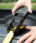 Close-up of Heavy Duty Ratchet Tie Down Straps 1.5 Inch by 16 Foot, 1100 Lb Safe Working Load, 3300 Lb Break Strength being secured