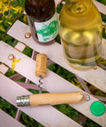 Killer Stainless Steel Folding Pocket Knife With Integrated Wine Corkscrew And Bottle Opener Solid Beechwood Handle on a picnic table.