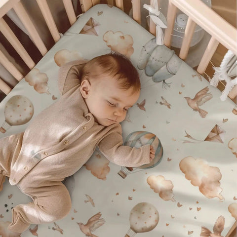 Sleeping baby on Balloon Transportation Pattern Baby Crib Sheets For Unisex Nursery Decor Featuring Balloons Clouds And Birds Fitted Sheet 28x52