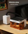 D5 Laser Engraver Air Purifier For P1 5W Mini Smoke Purifier with 3 Layer Fume Extractor on table next to laser cutter