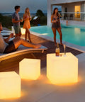Rechargeable LED Cube Chair Light With Remote, 16 Inch Glow Cube Seat Doubles As Waterproof Cube Table by poolside at night