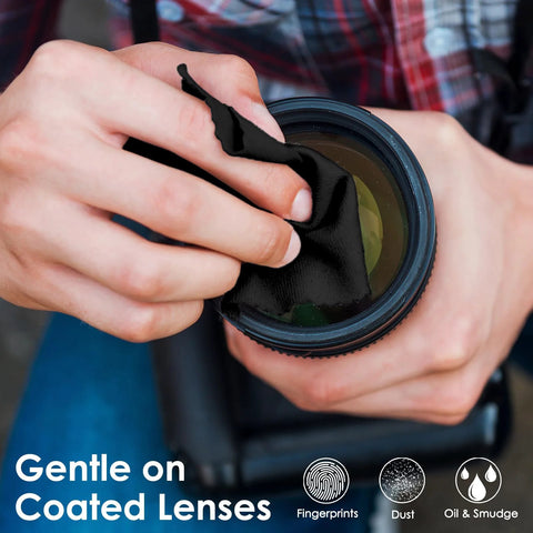 Camera lens cleaning cloth, black microfiber, used to wipe a lens (close-up view)