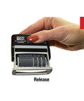 Hand demonstrating the release feature of the Slick Self Inking Micro Message Dater Stamp With Quick Flip Phrases.