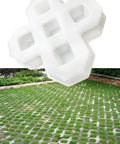 Reusable Plastic Grass Paver Molds With Five Hole Design For Concrete Pavers For Grass Driveways Walkways Parking And Landscaping Edging Made Of Durable ABS For DIY Friendly Reuse, shown in use on a grass driveway.