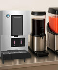 Rock Solid Commercial Cubelet Nugget Ice And Water Dispenser Features Hands Free Operation And Built In Storage Box That Churns Out 257 Lbs Of Chilled Ice Daily To Keep Your Commercial Kitchen Running Smooth on a countertop with beverage dispensers.