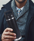 Man holding a black Rambler bottle with Screw Top Lid Replacement For Rambler Bottle 18 26 36 46 64 Oz No Spill Chug Cap Replacement Lids