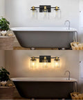 Three Light Black And Gold Bathroom Vanity Light Fixtures Over Mirror With Clear Glass Shade above a bathtub