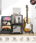 Bikoney Multi-Functional Record Player Stand And Guitar Rack For Acoustic Electric Bass With Amp Shelf in living room with vinyl records.