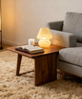 Cordless Mushroom Lamp With Battery Power And Timer on wooden side table, warm white LED, cozy cloud decor in living room.