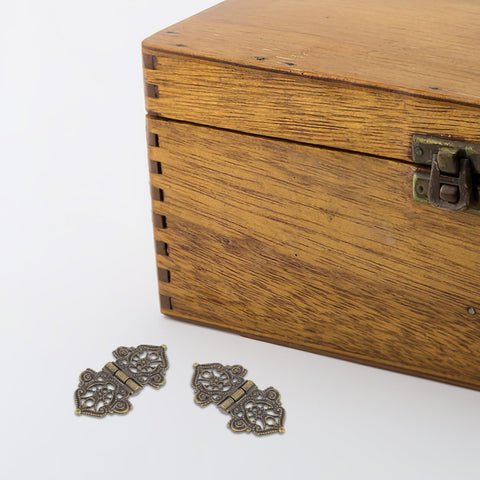 Golden Zinc Alloy Hinges Set Retro Decorative 10 Pieces for Wood Boxes and Small Boxes displayed with wooden box