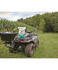 UTV And ATV Receiver Mount Broadcast Spreader Seeder For Easy Lawn And Garden Seeding 80 Pound Capacity 12 Volt Power Quick Install Harness Rain Cover Included on ATV in a field