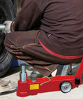 Beefy Heavy Duty Hydraulic Horizontal Jack Accessory With Pressure Relief Valve For Construction Sites And Auto Repair, Durable Metal Build, Easy Install Spare Part, red metal floor jack accessory on vehicle wheel