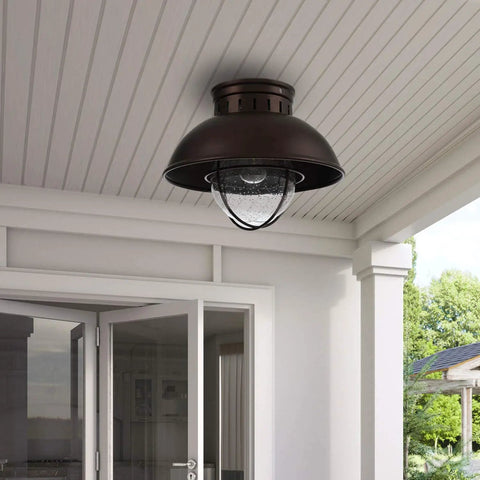 Outdoor Farmhouse Ceiling Light 10 Inch Flush Mount In Oil Rubbed Bronze With Metal Cage And Seeded Glass Semi Entry Hall Light Fixture For Porch Patio Or Foyer installed on porch ceiling.