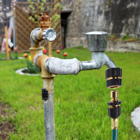 Outdoor pipe with Premium Aluminum Three Quarter Inch Garden Hose Quick Connectors Set Of Four attached to a hose in a garden