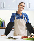 Tough As Nails Four Pack Waterproof Arm Sleeves With Thick Elbow Guards Grease Proof Oil Resistant Protective Oversleeves For Mechanics Shop Floor And Weekend Grind In Black worn by a woman in the kitchen.