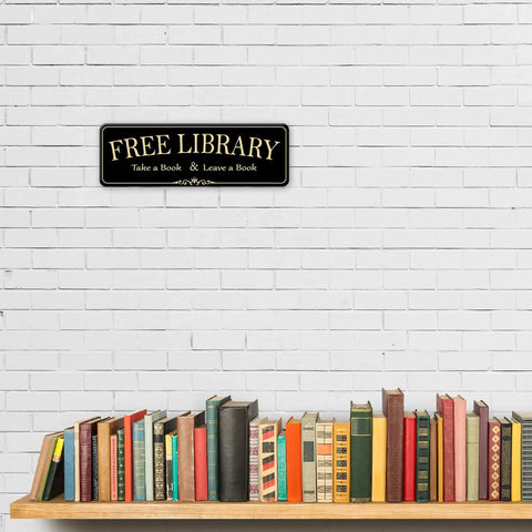 Acrylic 9x3 Inch Free Library Sign Self Stick Door Wall Signage in royal black finish above a row of books on a shelf.