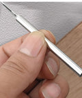 Hand holding pilot sleeve tool for Rock Solid Grip Smooth Sailing Install Kickass Carbon Steel Double Head Baseboard Screws.