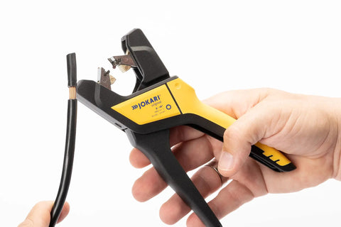 Automatic Wire Stripper For 6 To 16 AWG Cables, Pro Grade Hand Tool With Built Tough Design in use, close-up on yellow handle