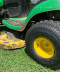 Side view of Tubeless Pneumatic Tire and Wheel Assembly 20x8.00-8 Turf Traction Tread For Riding Mowers Replacement Rear Tire 2 Pack Fits John Deere Lawn Tractors Compatible, installed on a green lawn tractor.