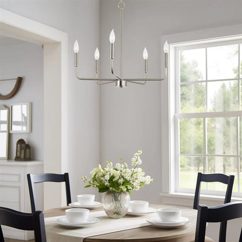 Camille 22 Inch Modern 5-Light Candle Style Chandelier With Open Frame In Brushed Nickel Finish illuminating a dining room.